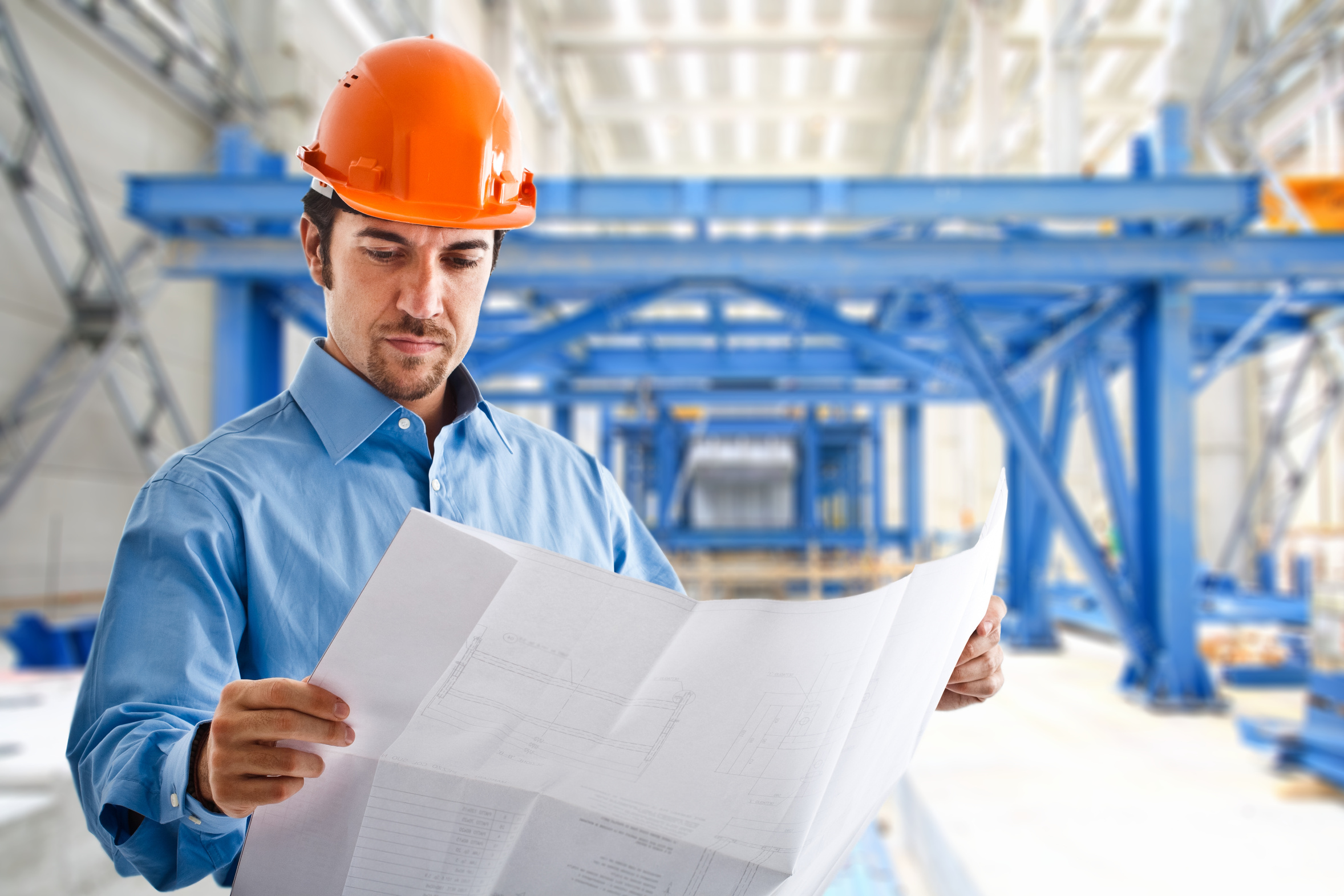 man in a hard hat looking at construction plans