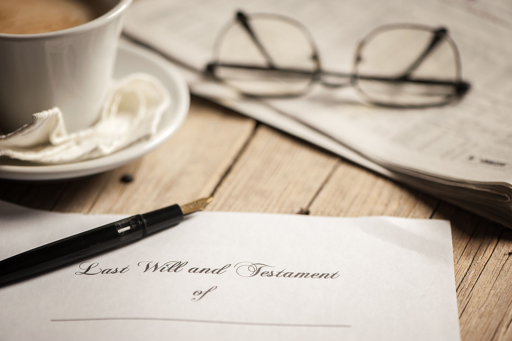 last will and testament with glasses and a pen