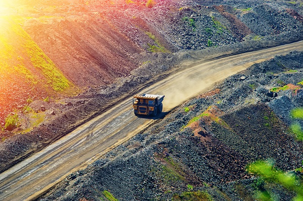 mining tipper truck driving on dirt road