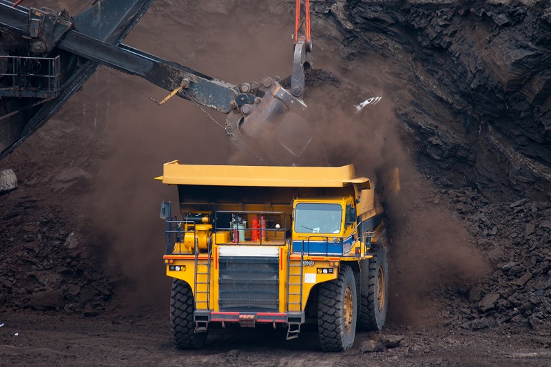 large yellow mining truck filled with coal Resources Unearthed